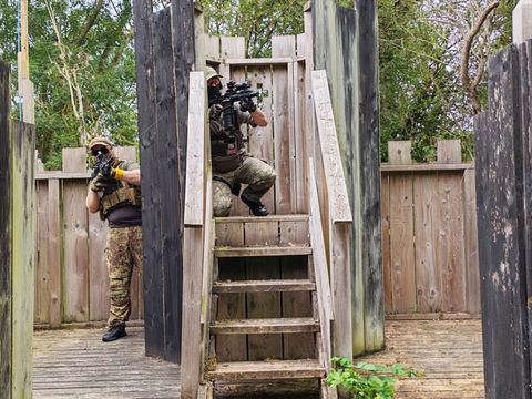 A wooden fort with a player on the stairs