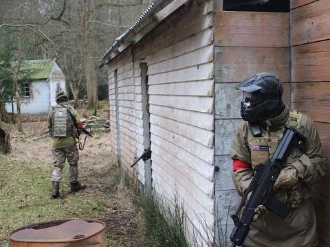 Players by a wooden building