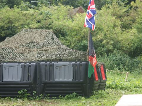 The camo-netted bunker and flags