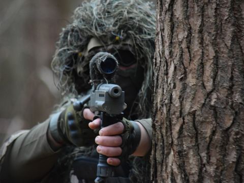 A player in a ghillie suit