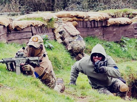 Players moving along a sandbagged trench