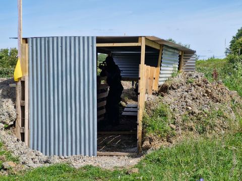A clad bunker built into an earth bank