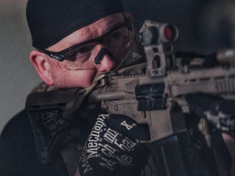 Bryan aiming one of his upgraded airsoft rifles