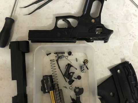 Gas pistol stripped into parts for repair
