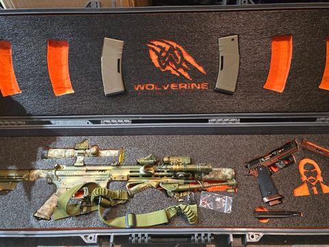 Camo rifle and pistol set in a Wolverine-branded shadow foam case layout
