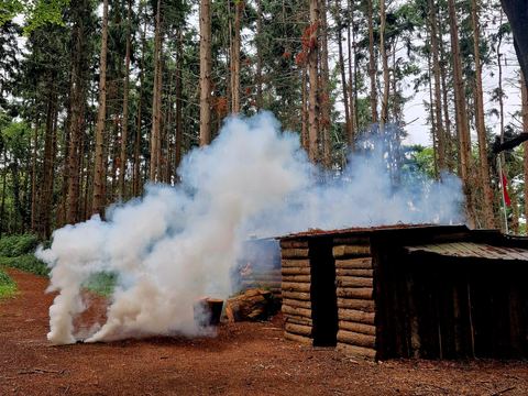 Smoke beside a log built bunker