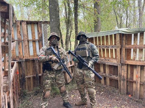 Two players in a pallet built CQB structure