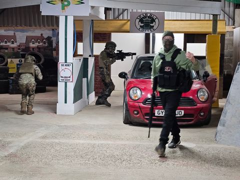 Players advancing past a car