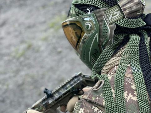 An airsoft player in full face protection