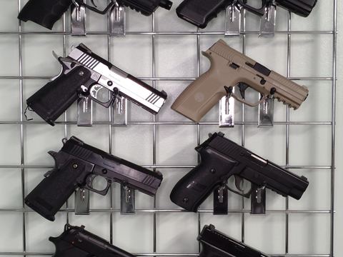 Gas pistols racked on the wall