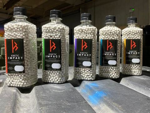 Bottles of BBs lined up on a case in the shop