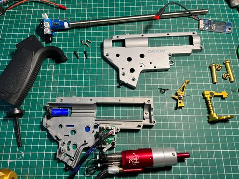 An AEG gearbox stripped down on the bench for a repair