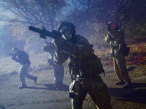 Players moving through smoke at the site