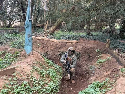 Player in a dug-out trench on the site