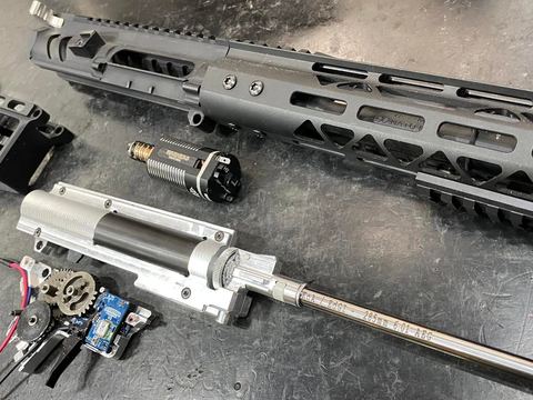 Stripped AEG with gearbox, motor and rail laid out for work
