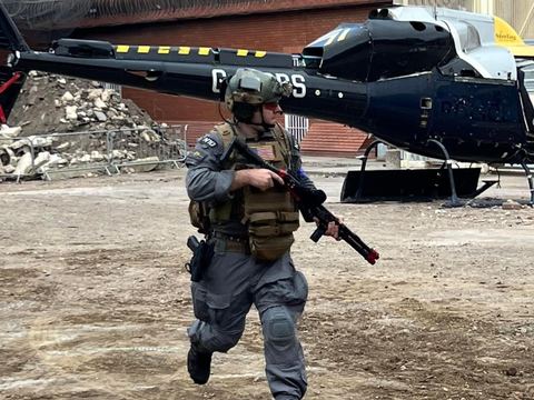 Player running past the helicopter prop on the prison site