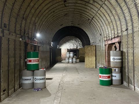 Inside the D-Day bunker tunnel, with oil drums as cover