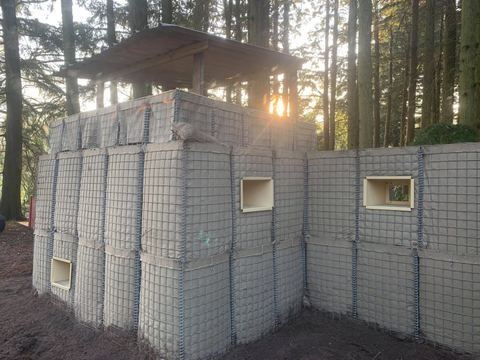 Gabion-wall fort in the woodland site at sunset