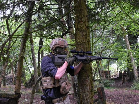 Player with a scoped rifle among the trees
