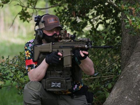 Player kneeling by a tree