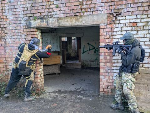 Players clearing a brick building