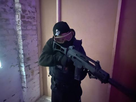 Player aiming a rifle indoors