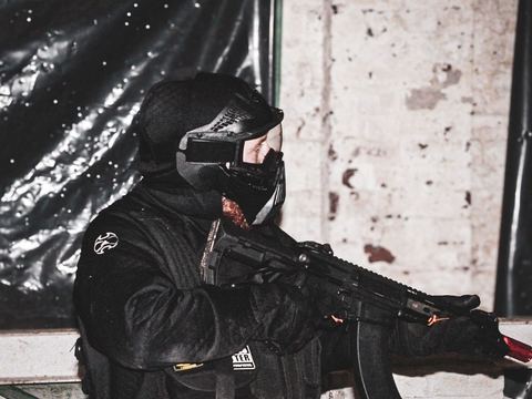 Player with a rifle by a wall