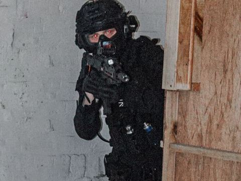 Player aiming a pistol around cover