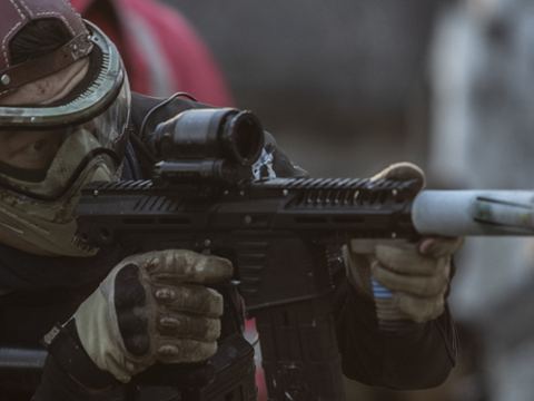 Airsoft player aiming in the game zone