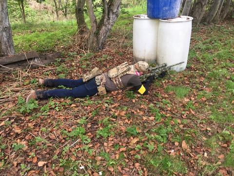 An airsoft player on the woodland floor